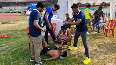 shivaji parashuram being treated after he collapsed at the end of the 10000m race on friday